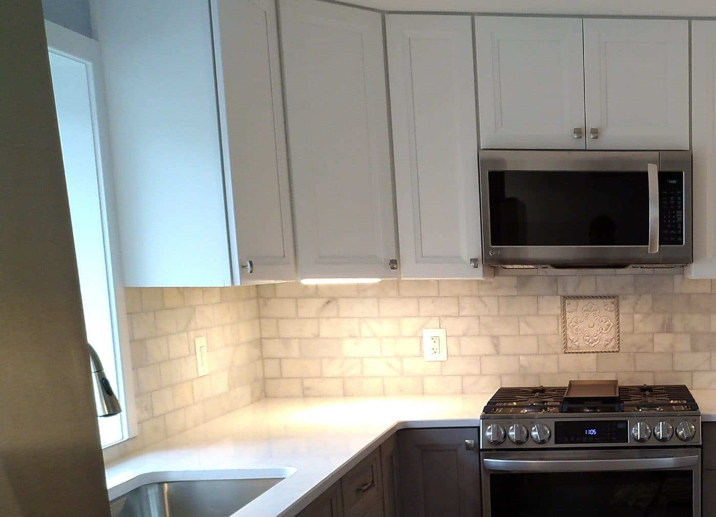 Completed KJC kitchen install — white shaker cabinets, quartz counters, marble subway backsplash